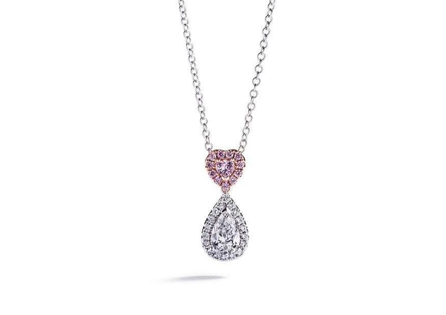 Vedhæng i 18 kt. hvidguld prydet med en 0,64 ct. dråbesleben River(E)/VVS2 diamant omkranset af 18 Top Wesselton/VVS diamanter, i alt 0,13 ct. samt en hjertesleben Natural Fancy Intense Pink/SI diamant omkranset af 11 Natural Fancy Intense Pink/SI brillanter